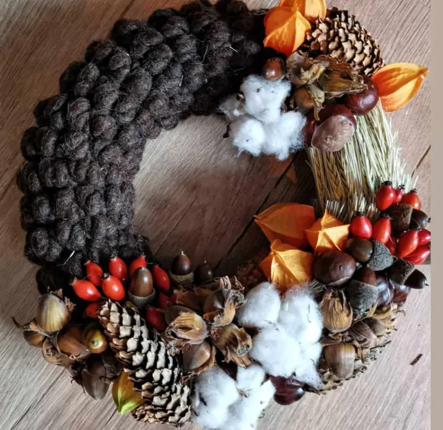 Wreath with natural materials on wooden surface.