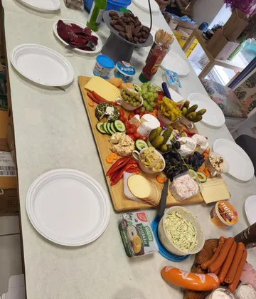 Variety of foods on table with plates.