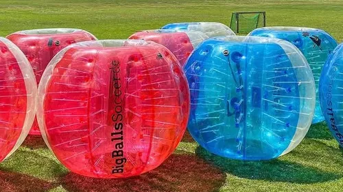 Inflatable balls on a grassy field.