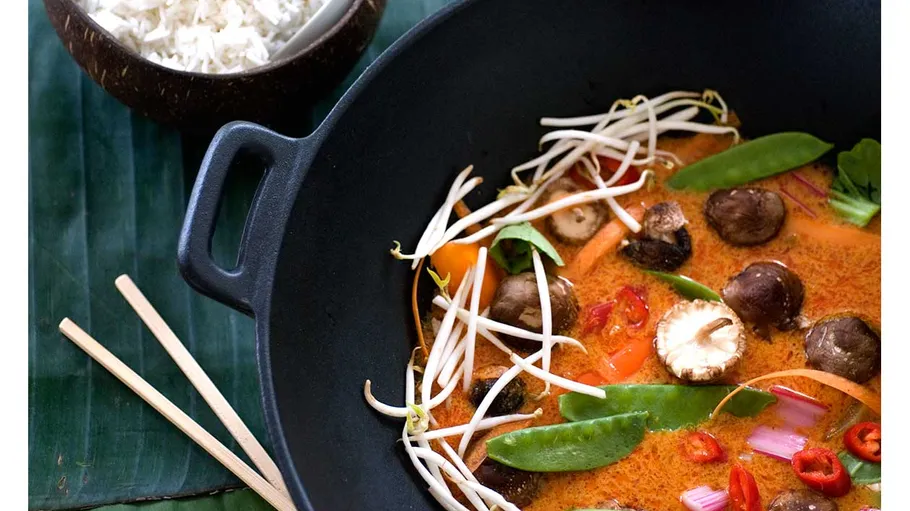 Vegetable curry with rice served in bowls.