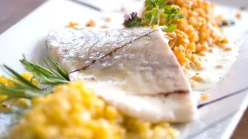 Grilled fish fillet with garnished lentils.