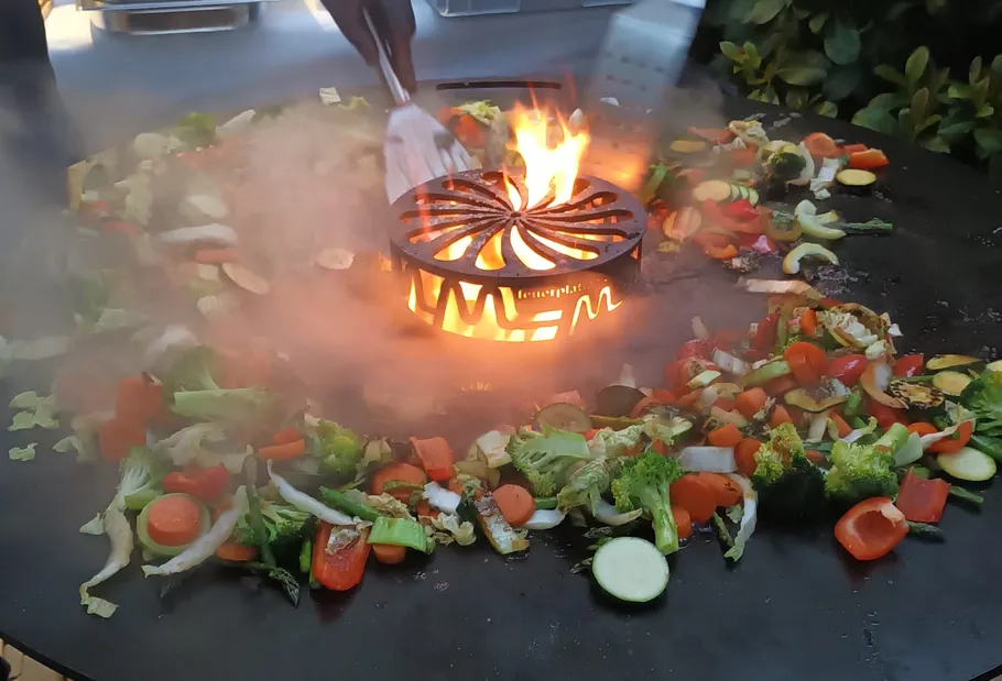 Gemüse auf Grill im Freien mit Flammen.