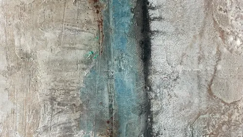Abstract textured wall with blue and grey tones.