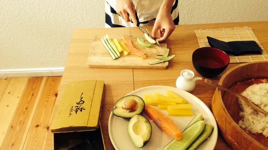 Person slicing vegetables on wooden board.