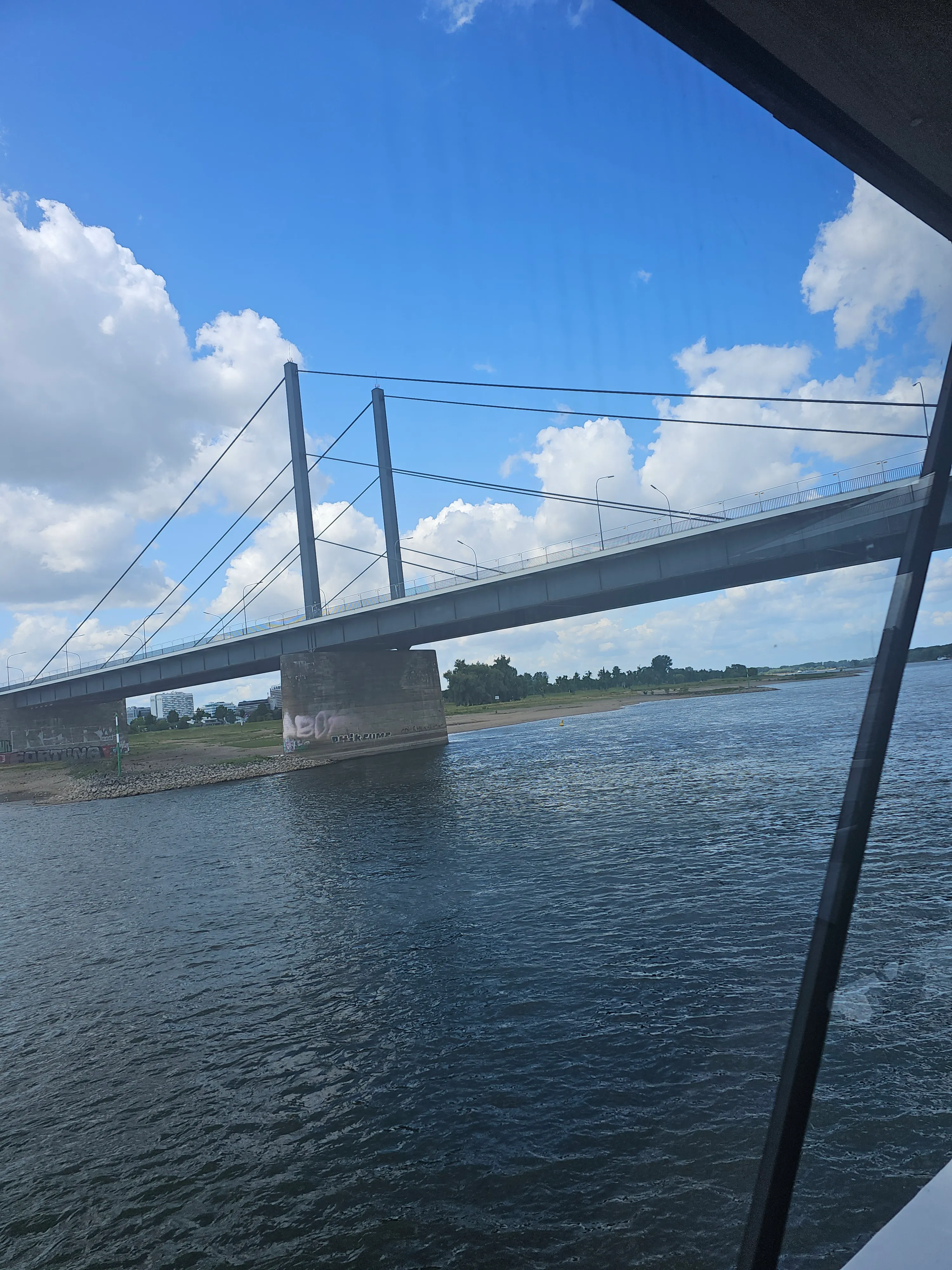Bridge crossing over a wide river scene.