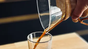 Coffee being poured into a glass.