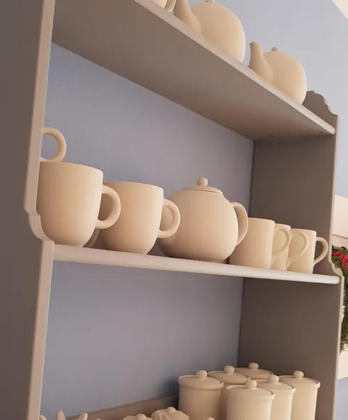 Ceramic mugs and teapots on a shelf.
