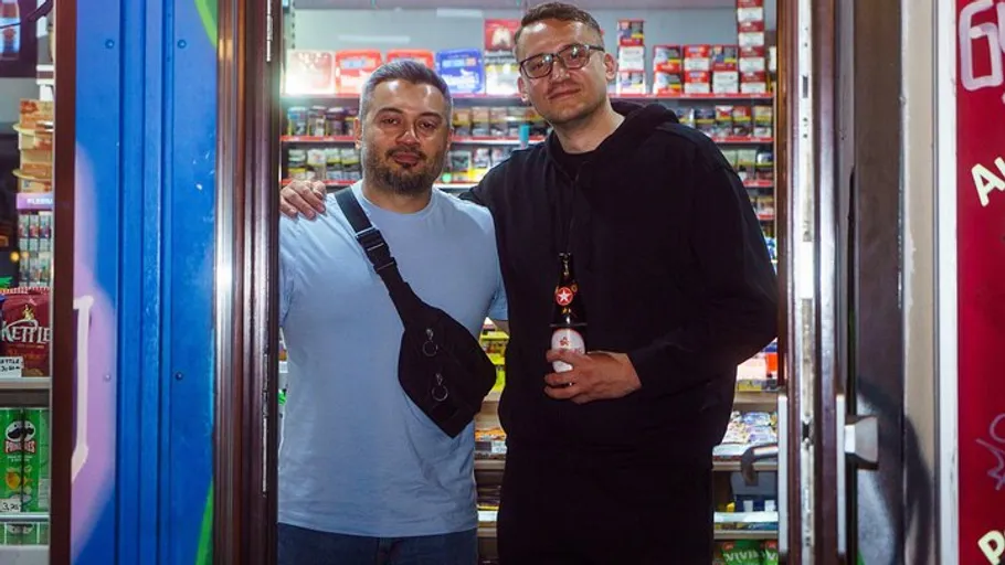 Two men standing in a store entrance.