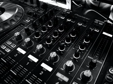 DJ controller with controls, supervised by a DJ