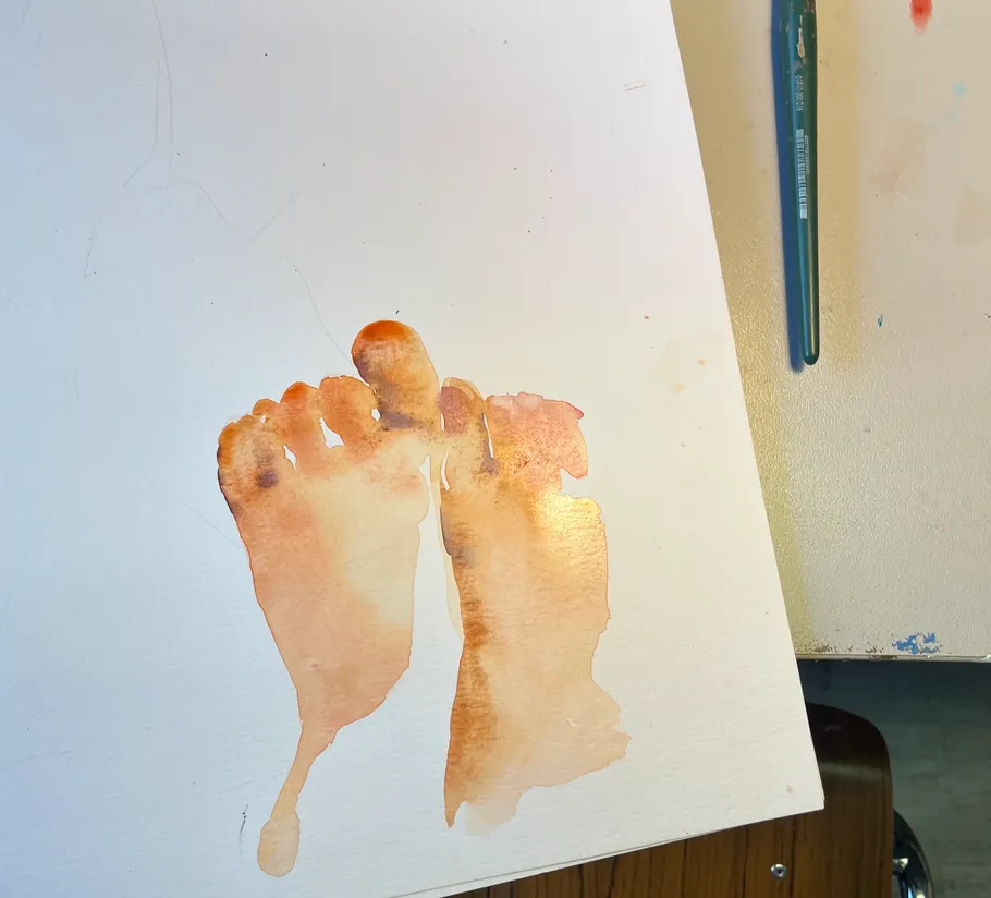 Watercolor painting of feet on white paper.