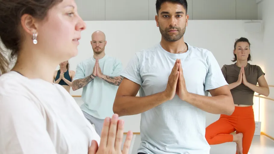 People practicing yoga in a studio.
