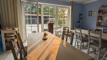 Room with tables and sunlight through window.