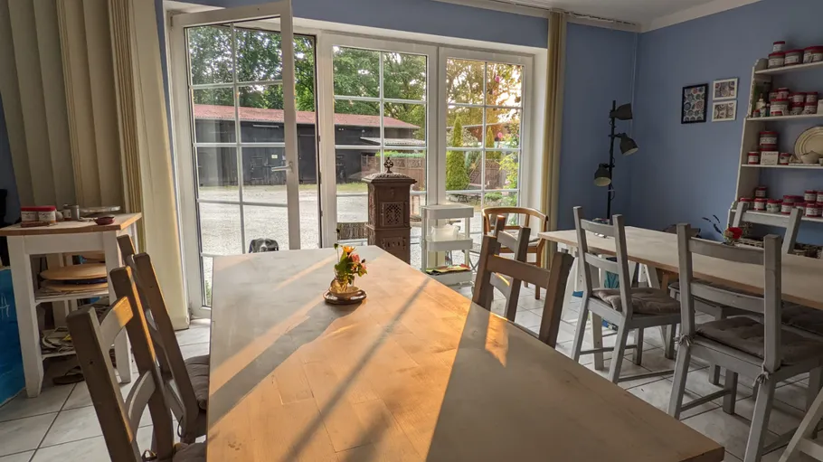 Room with tables and sunlight through window.