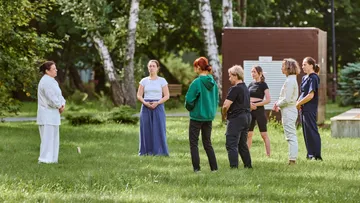 People practicing Tai Chi in a park.