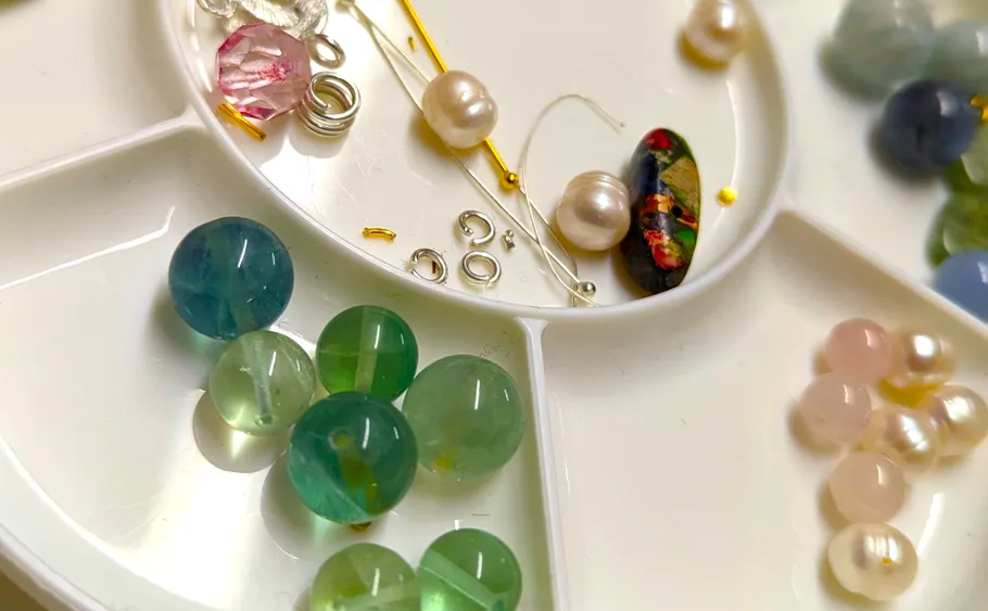 Beads and pearls on a plastic organizer.