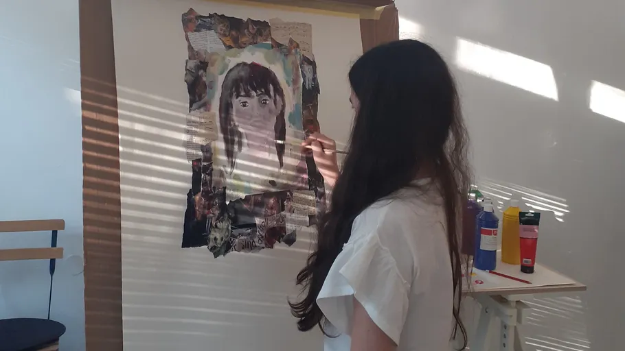 Person painting a portrait indoors with light stripes.