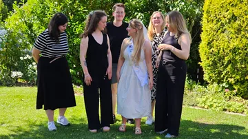 Group of people standing together outdoors.