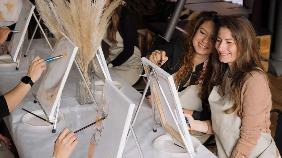 Two women painting at an art class.