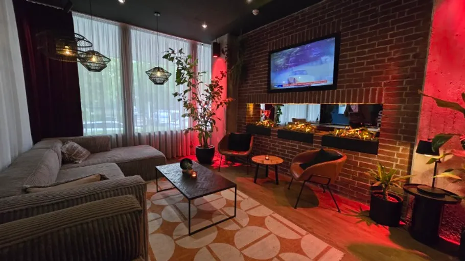 Gemütliche Lounge mit Backsteinwand und Fernseher.