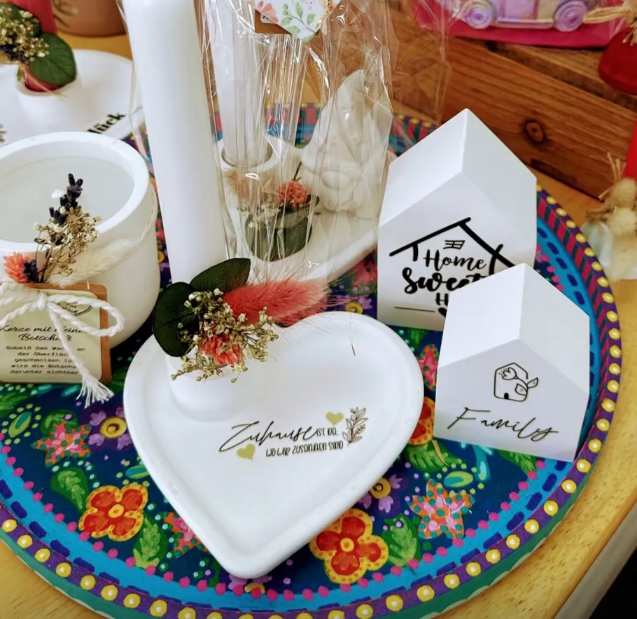 Decorative objects on colorful plate, floral accents.