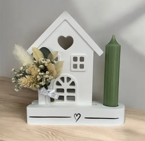 White house decor with candle and flowers.