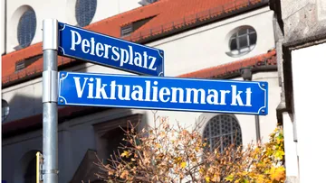 Street signs in front of a building.