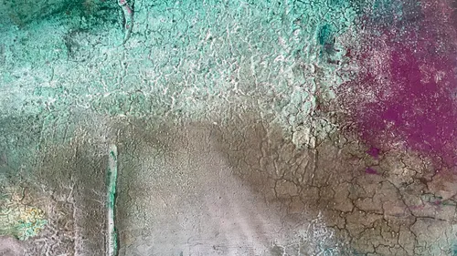Textured abstract art with green and purple hues.