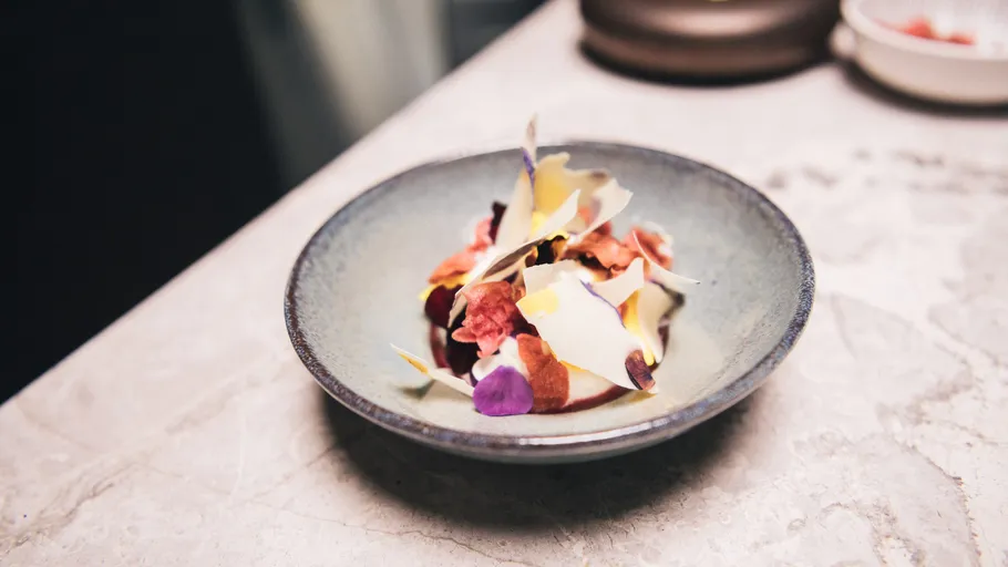 Gourmet dish with decorative elements on plate.