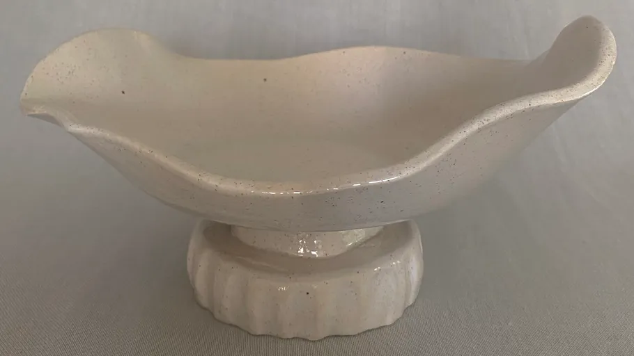 White ceramic dish on a pedestal stand.