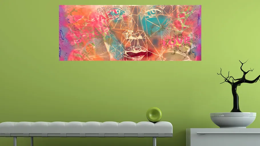 Abstract face artwork on green wall.
