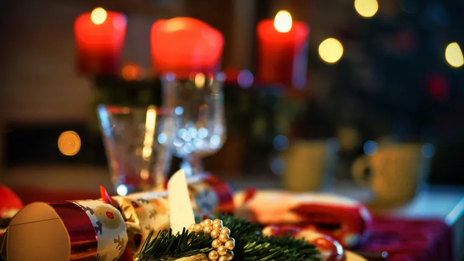 Christmas table setting with candles and decorations.