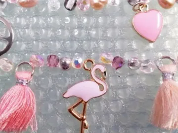 Jewelry with colorful pearls and pendants, including a flamingo