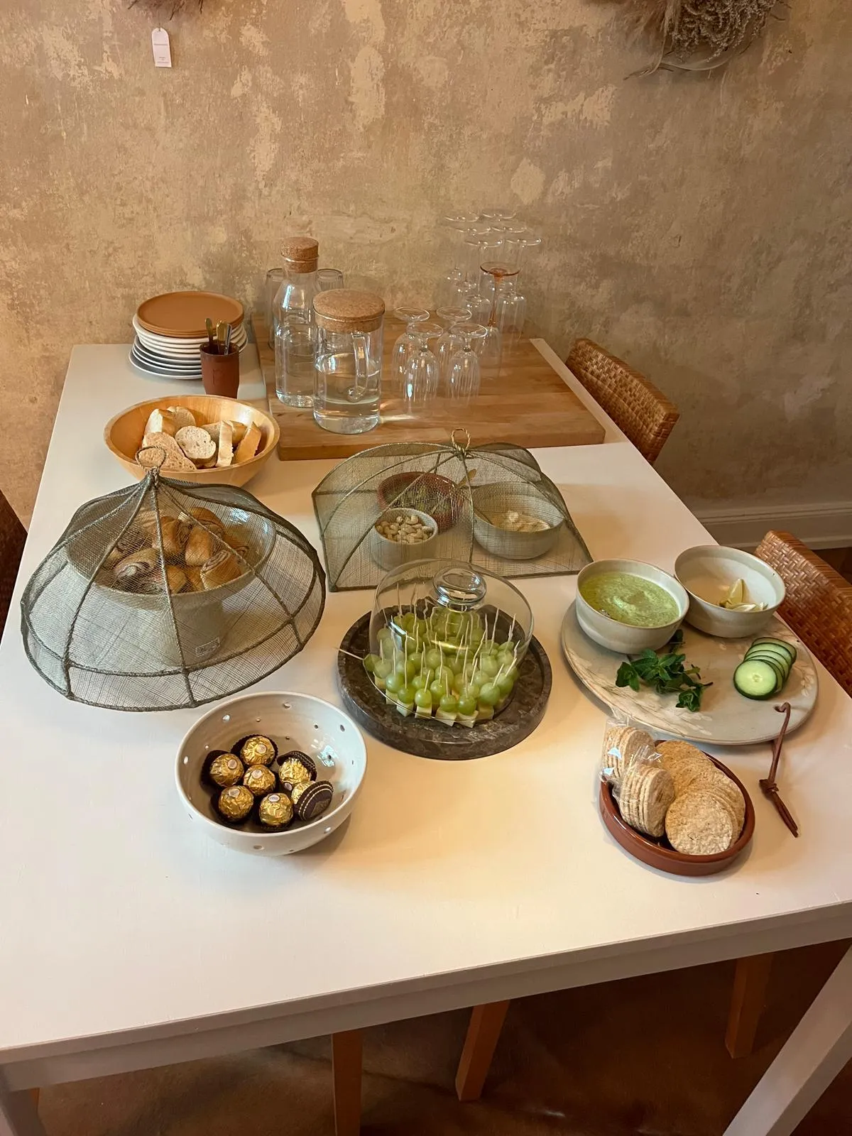Table with snacks under mesh covers.