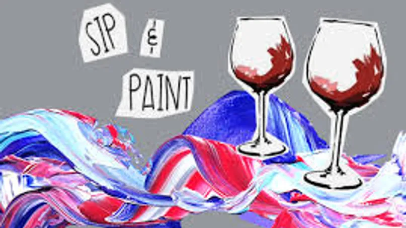 Two wine glasses above colorful paint swirls.