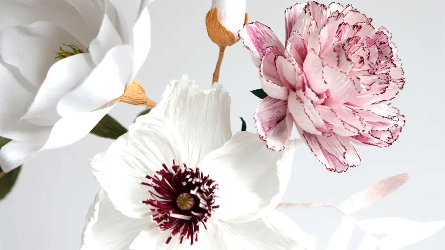 Paper flowers arranged against a neutral backdrop.