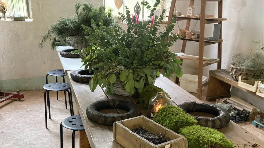 Floral arrangement workshop with green foliage.