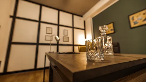 Glass on desk in stylish office room.