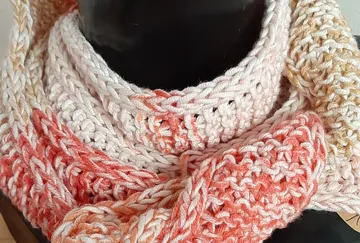 Knitted scarf on black mannequin bust.