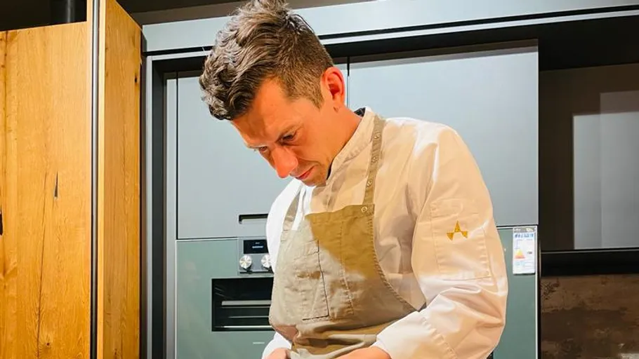 Chef cooking in modern kitchen.