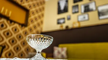 Crystal glass on table, retro living room.