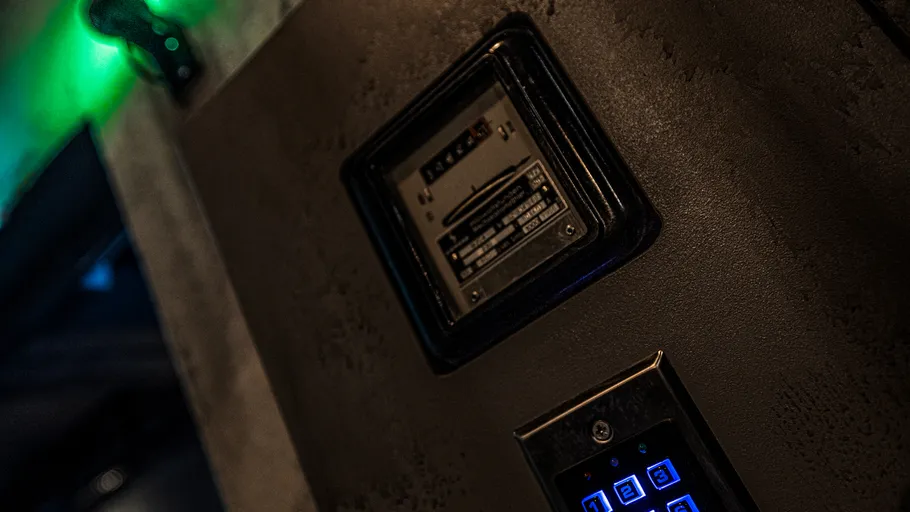 Keypad and panel on dark wall, dim lighting.