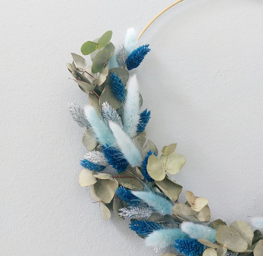 Decorative wreath with blue and green accents.