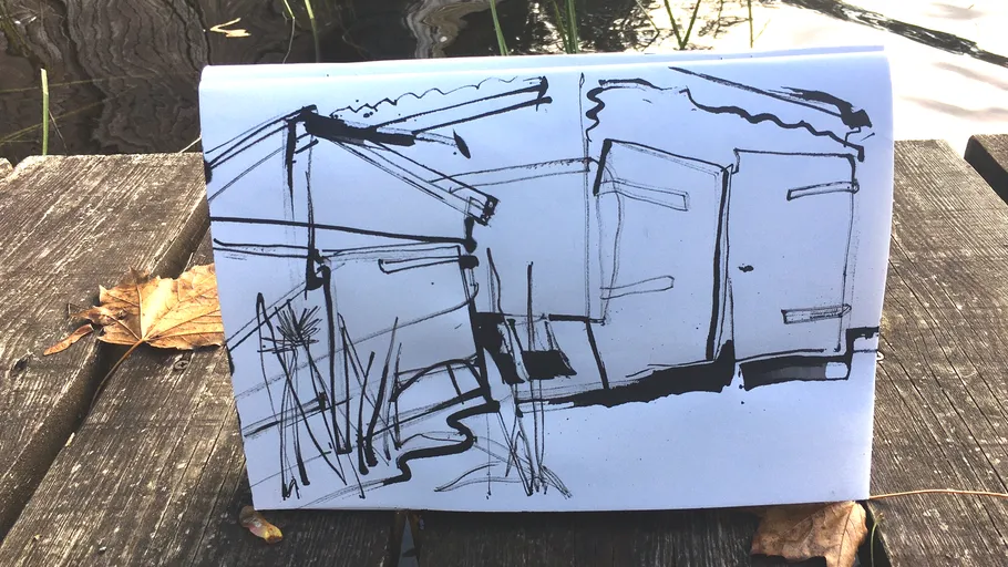Sketch of huts on a table by water.
