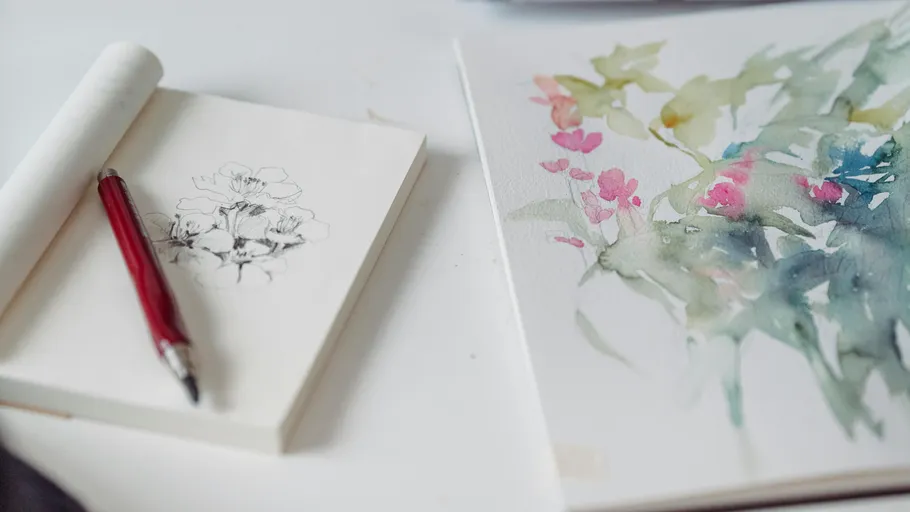 Sketch and watercolor painting on table.
