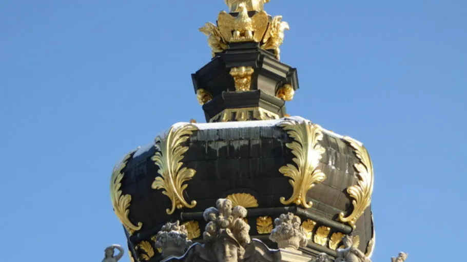 Ornate dome with gold accents, blue sky.