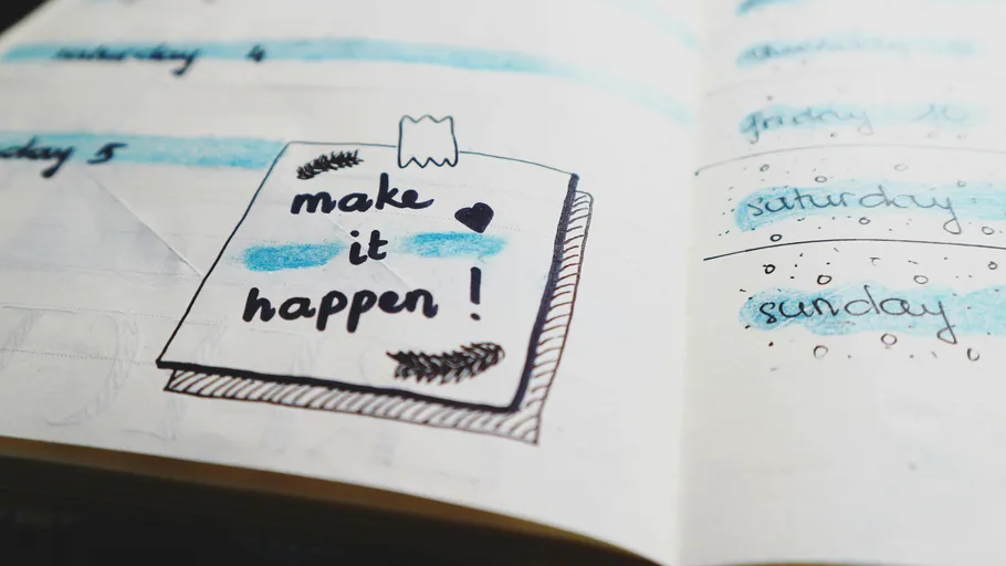 Notebook with motivational doodles and calendar.