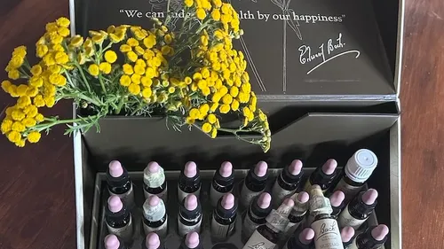 Open box with flower and bottles inside.