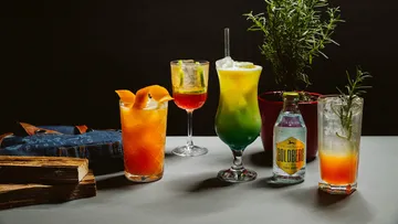 Colorful cocktails on table with plants.
