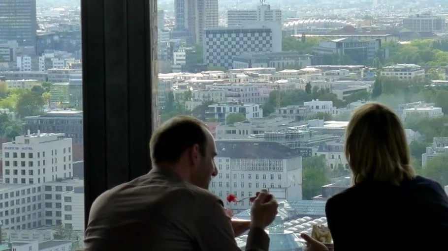 Zwei Personen essen mit Stadtblick.