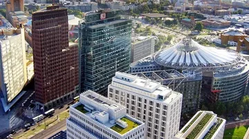 Aerial view of city skyscrapers and dome.